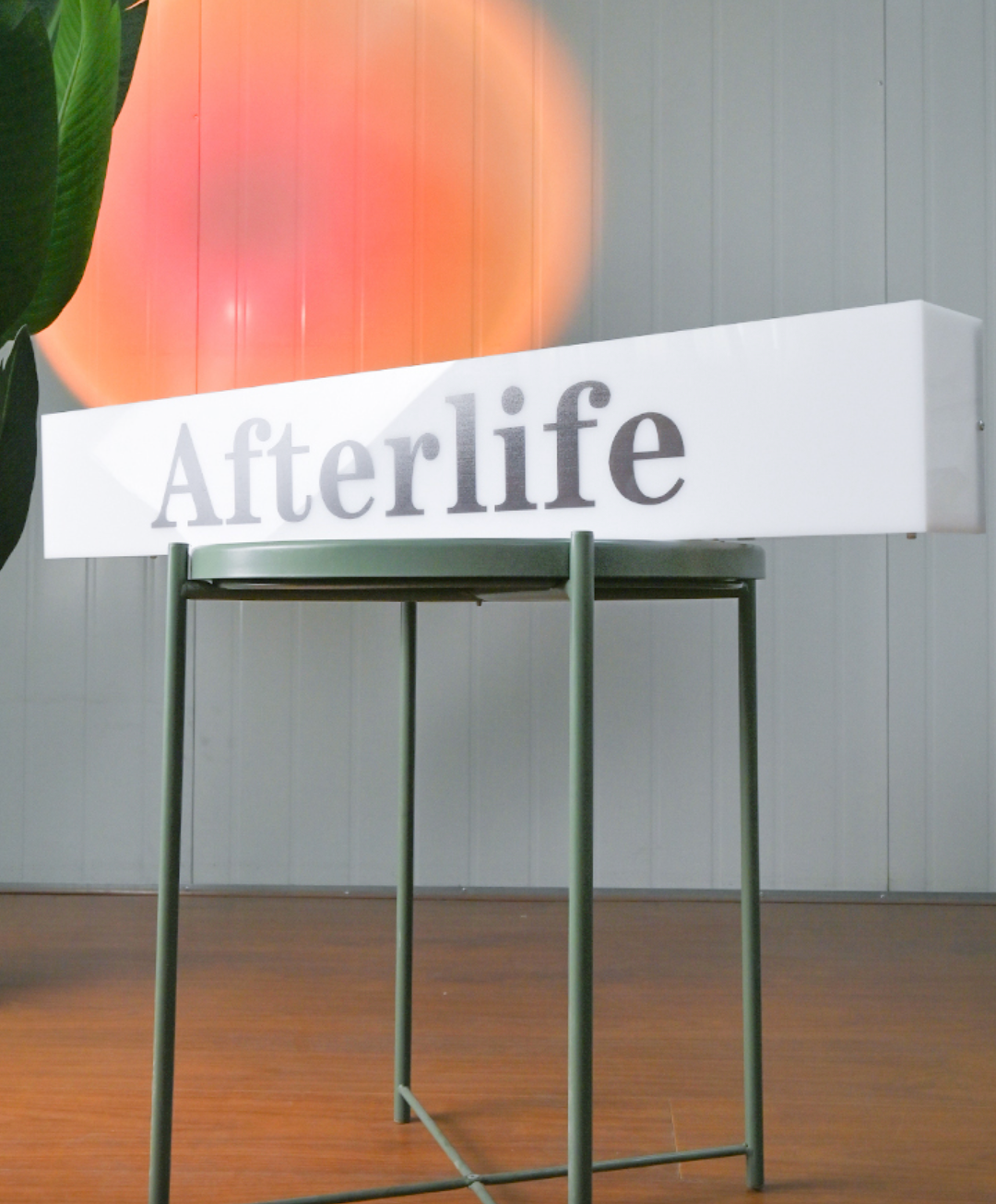 lightbox sign to afterlife on chair